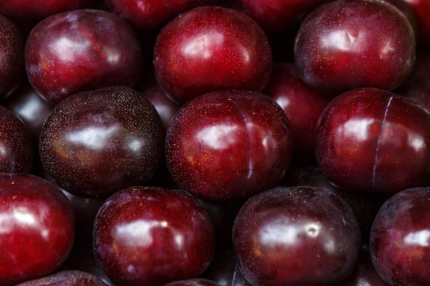 Ripe red plum fruit harvest background