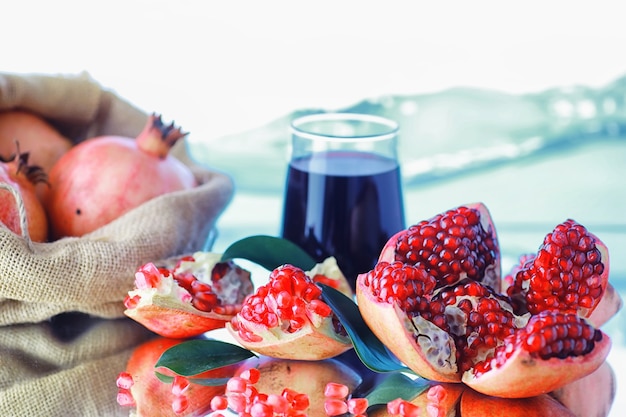 Ripe red pomegranate. Ripe grains of pomegranate on the table. Pomegranate juice.