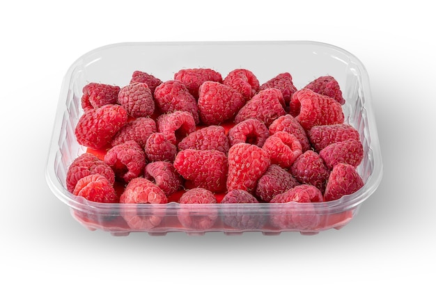 Ripe red raspberries in a plastic box isolated on a white background