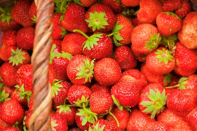 Ripe red strawberries in a basket background