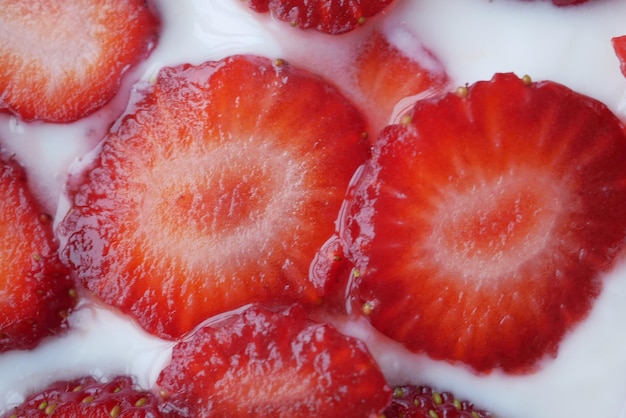 Ripe Red Strawberries and cream milk in a bowl on table