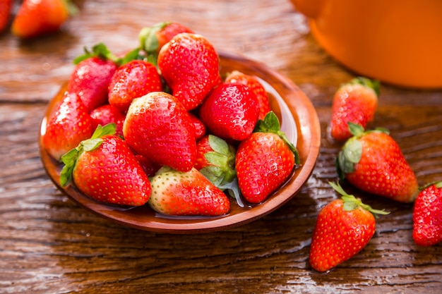 Ripe red strawberries on wooden table