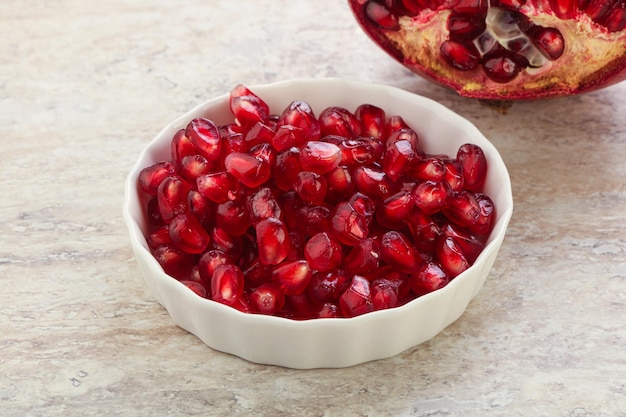 Ripe red sweet pomegranate seeds in the bowl