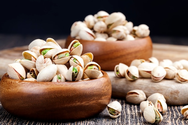 Ripe roasted pistachios sprinkled with salt, delicious natural dried and salted pistachio nuts