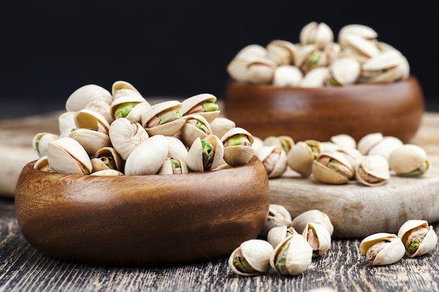 Ripe roasted pistachios sprinkled with salt, delicious natural dried and salted pistachio nuts