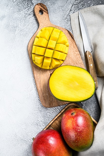 Ripe sliced mango fruit on a chopping board