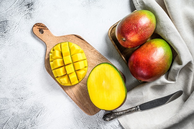 Ripe sliced mango fruit on a chopping board