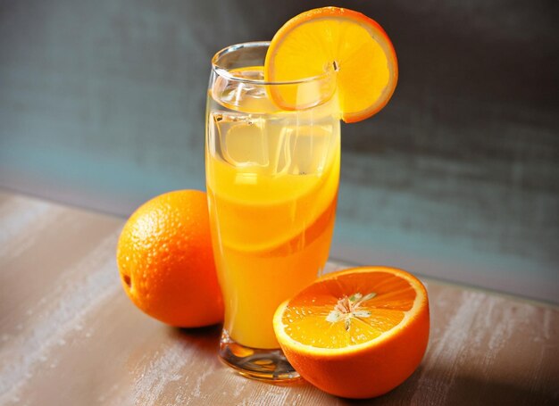 Ripe sliced orange and glass of juice citrus drink