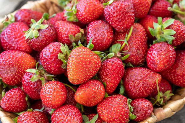 Ripe strawberries on a dark background Fresh strawberries in a basket Organic food close up