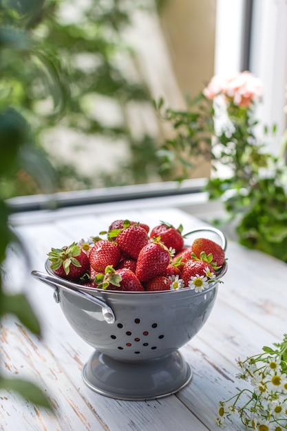 Ripe strawberries in gray colander
