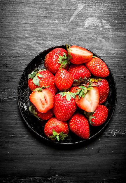 Ripe strawberries old plate.