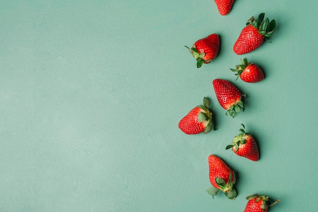 Ripe strawberries pile on a green table Fresh summer fruits