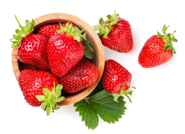 Ripe strawberries in a wooden plate closeup on a white backgroundTop view