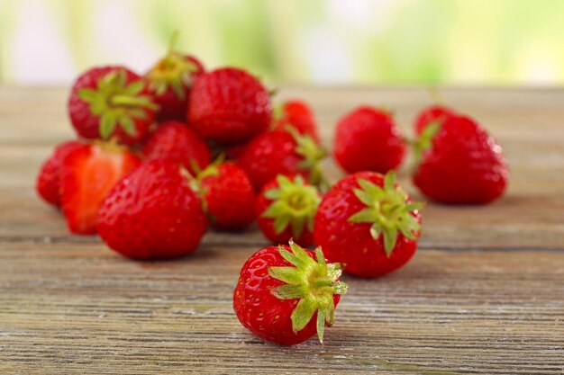 Ripe strawberries on wooden table closeup