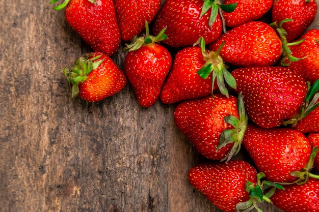 Ripe strawberries on wooden table. Fresh strawberries on wood