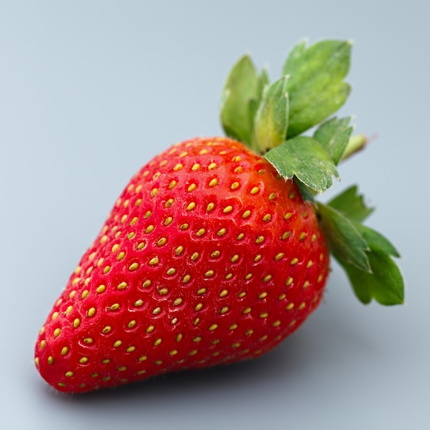 Ripe strawberry fruit on a gray background.