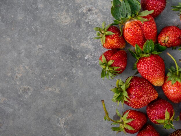 Ripe strawberry on a gray background.