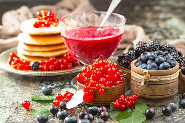 Ripe summer berries in a composition with drinks. 