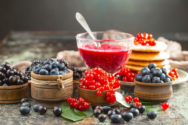 Ripe summer berries in a composition with drinks. 