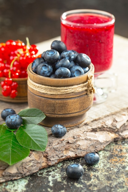 Ripe summer berries in a composition with drinks. 