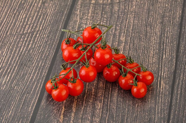 Ripe sweet Cherry tomato branch over background