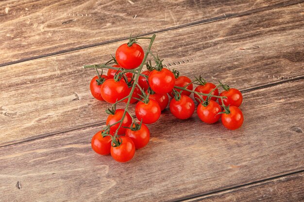 Ripe sweet Cherry tomato branch over background