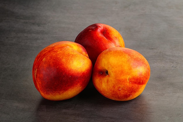 Ripe sweet juicy fresh red nectarines heap