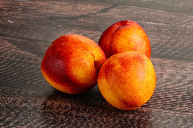 Ripe sweet juicy fresh red nectarines heap