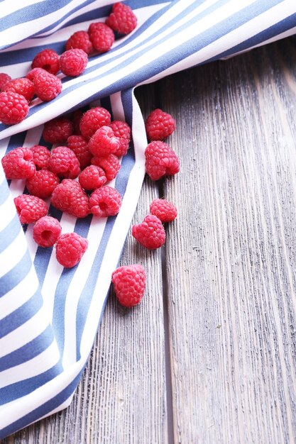 Photo ripe sweet raspberries on table closeup