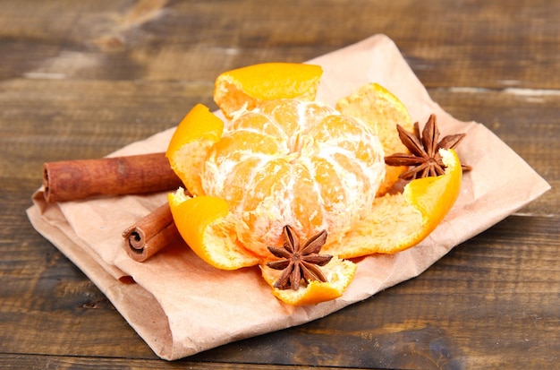 Ripe sweet tangerine on wooden background closeup