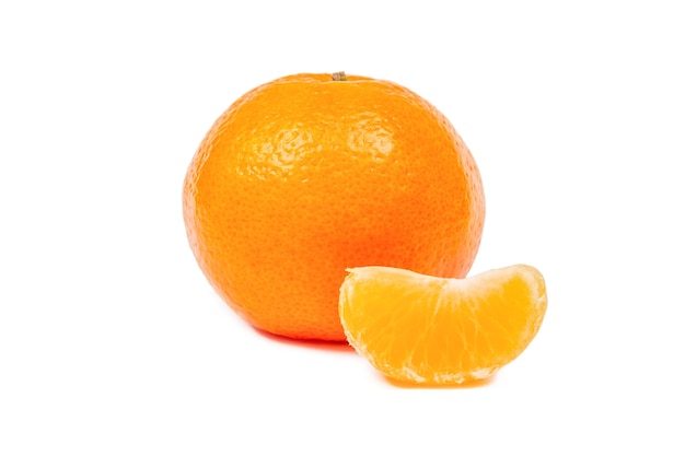 A ripe tangerine in the skin and a peeled Mandarin slice