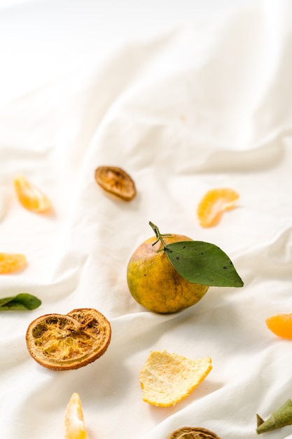 Ripe tangerine on white fabric