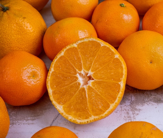 Ripe tangerines close-up one of them sliced.