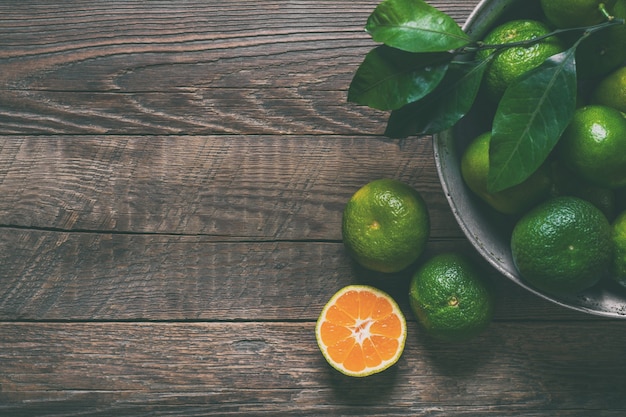 Ripe tangerines on wooden background