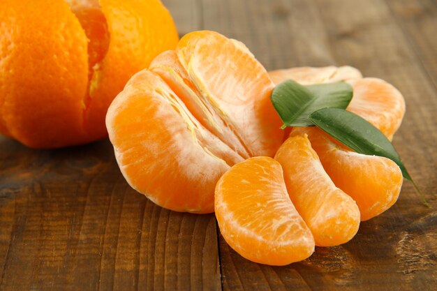 Ripe tangerines on wooden background