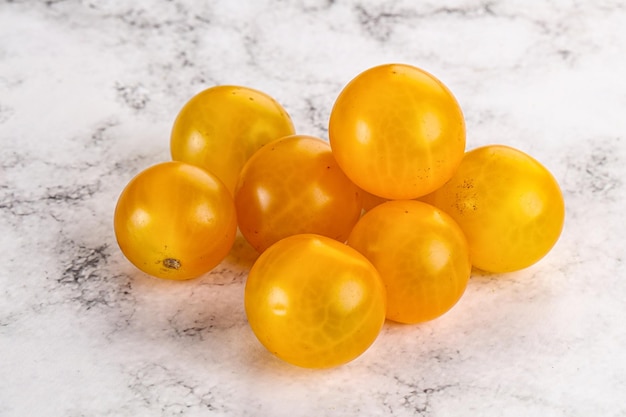 Ripe tasty yellow cherry tomato heap