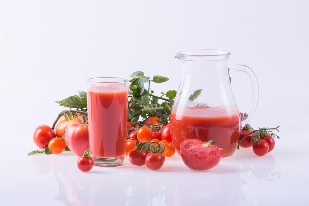 Ripe tomatoes of different sizes and juice Food background