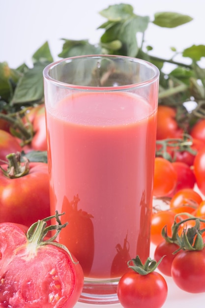 Ripe tomatoes of different sizes and juice Food background