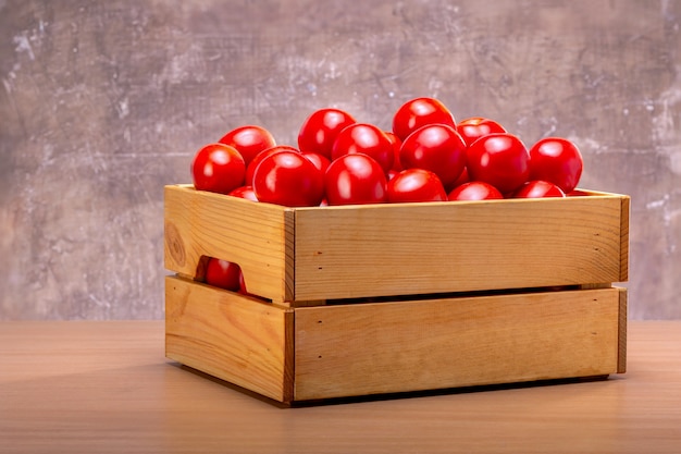 Ripe tomatoes in a wooden box.