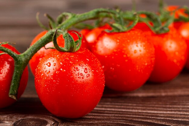 Ripe tomatoes on the wooden table