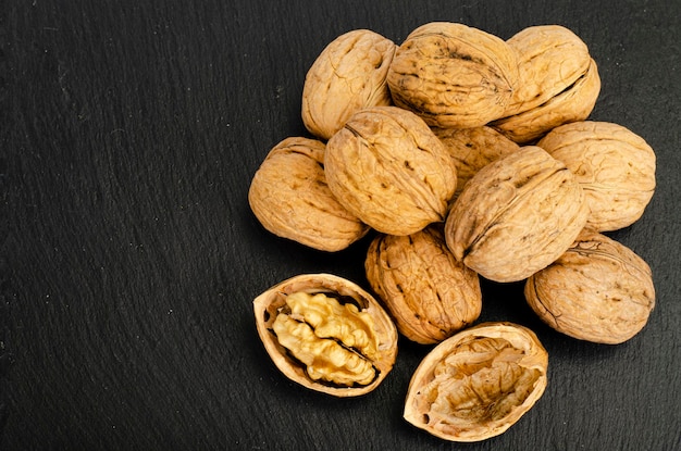 Ripe walnuts on black background. Studio Photo.