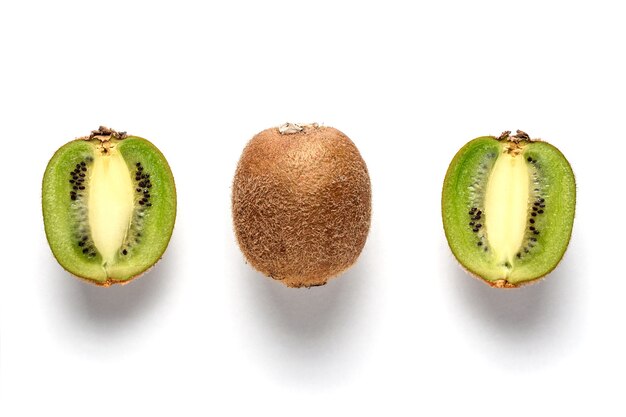 Ripe whole kiwi fruit and half kiwi fruit isolated on white surface.