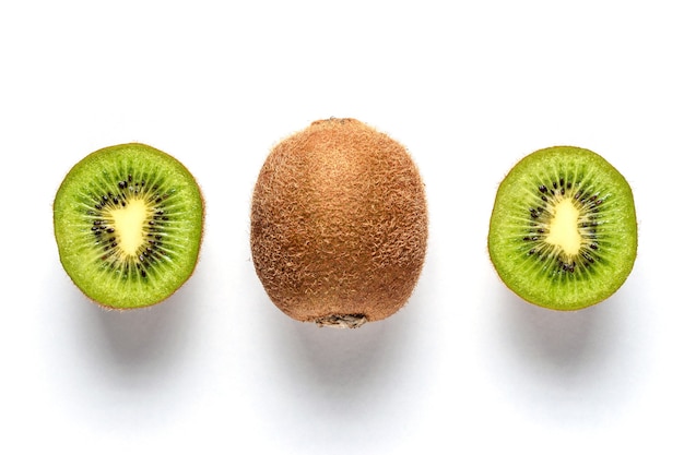 Ripe whole kiwi fruit and half kiwi fruit isolated on white surface.