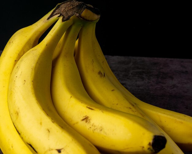 Ripe yellow bananas fruits bunch of ripe bananas isolated dark clipping path