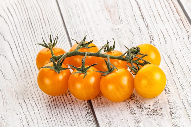 Ripe yellow cherry sweet tomato branch