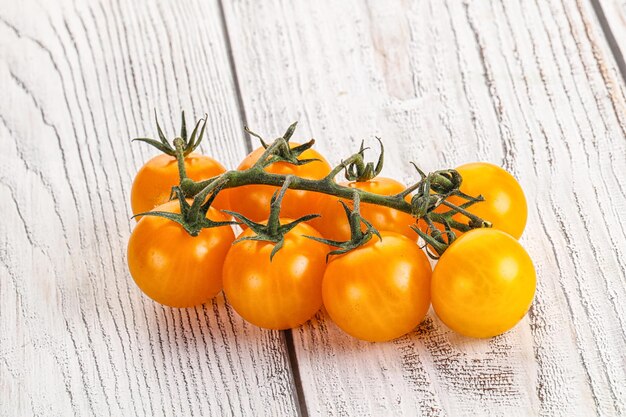 Ripe yellow cherry sweet tomato branch