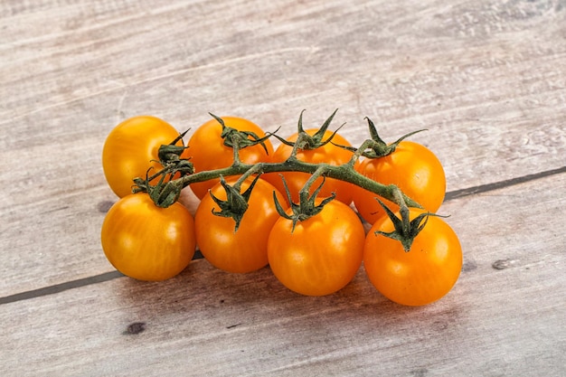 Ripe yellow cherry tomato branch