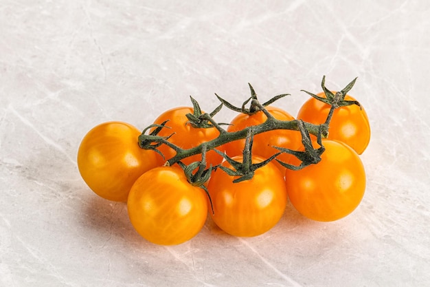 Ripe yellow cherry tomato branch