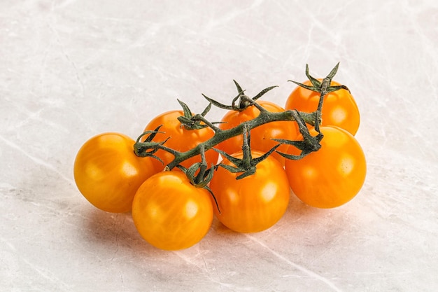 Ripe yellow cherry tomato branch