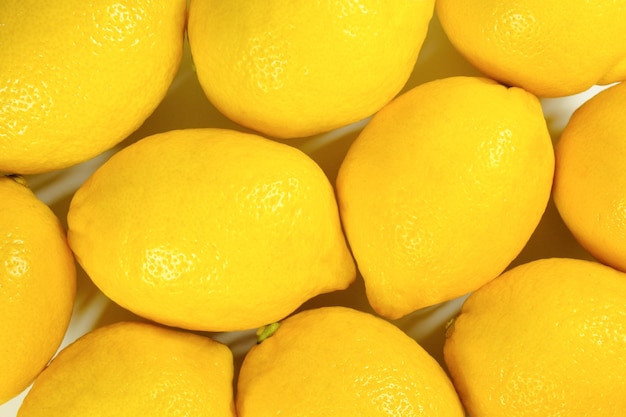 Ripe yellow lemons closeup Lemon background top view